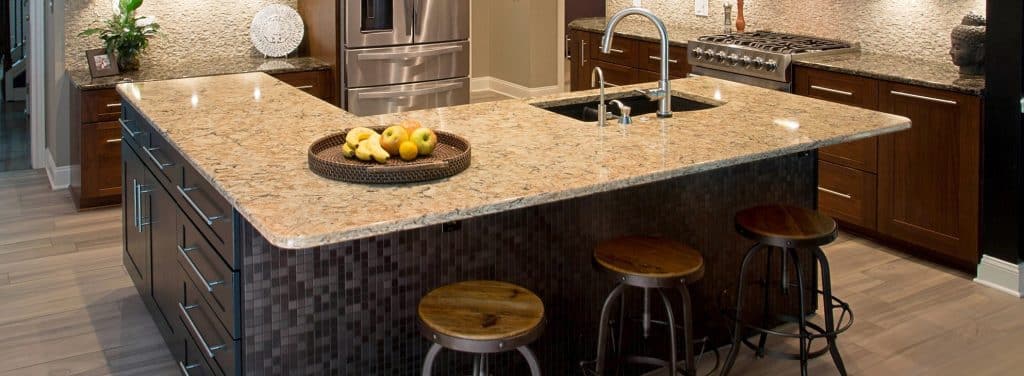 A set of cherry wood cabinets and a kitchen island