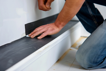 man adding veener to cabinets