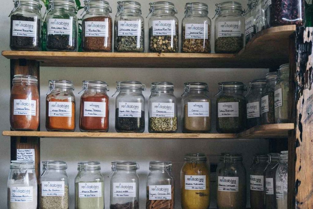 Clear Glass Jars on Wooden Shelf